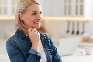 Photo of Happy middle aged woman indoors, space for text