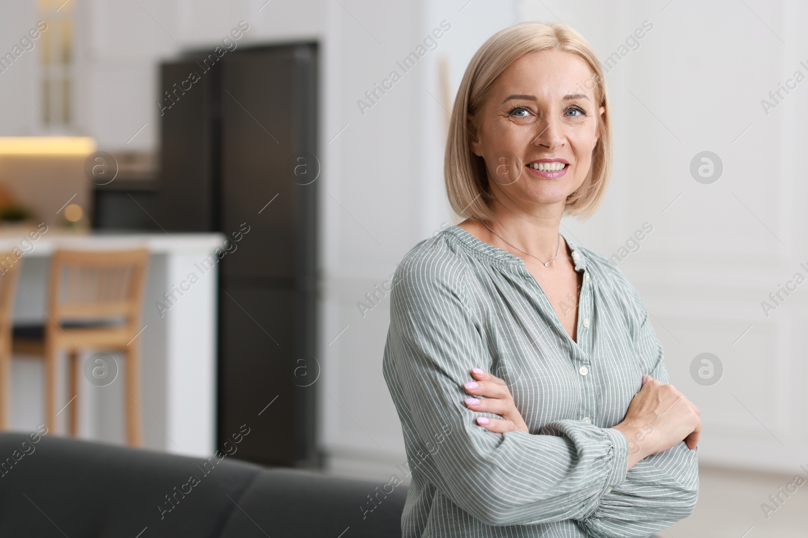 Photo of Portrait of happy middle aged woman indoors, space for text