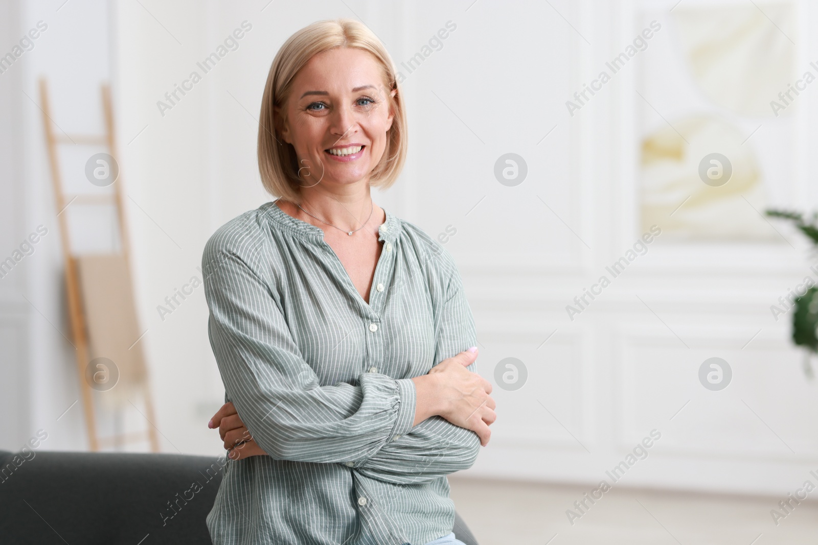 Photo of Portrait of happy middle aged woman indoors, space for text