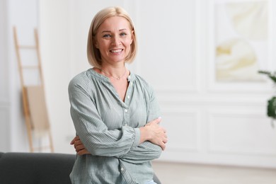 Photo of Portrait of happy middle aged woman indoors, space for text