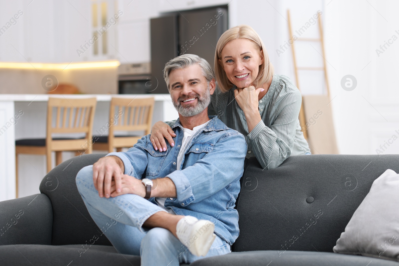 Photo of Portrait of happy middle aged couple in kitchen