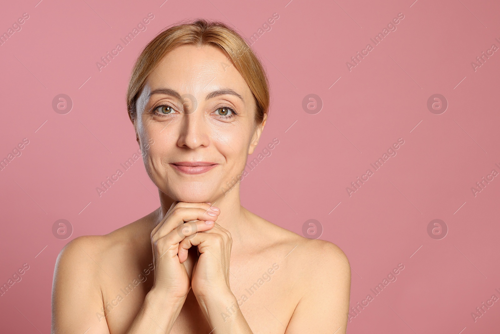 Photo of Portrait of beautiful woman with healthy skin on pink background. Space for text