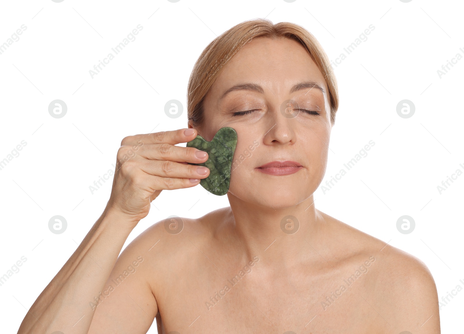 Photo of Beautiful woman doing facial self massage with gua sha tool on white background