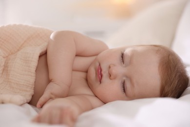 Cute little baby sleeping on bed at home