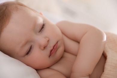 Cute little baby sleeping on bed at home