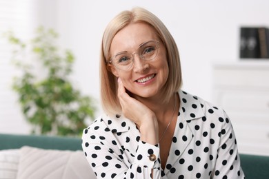 Portrait of smiling middle aged woman at home