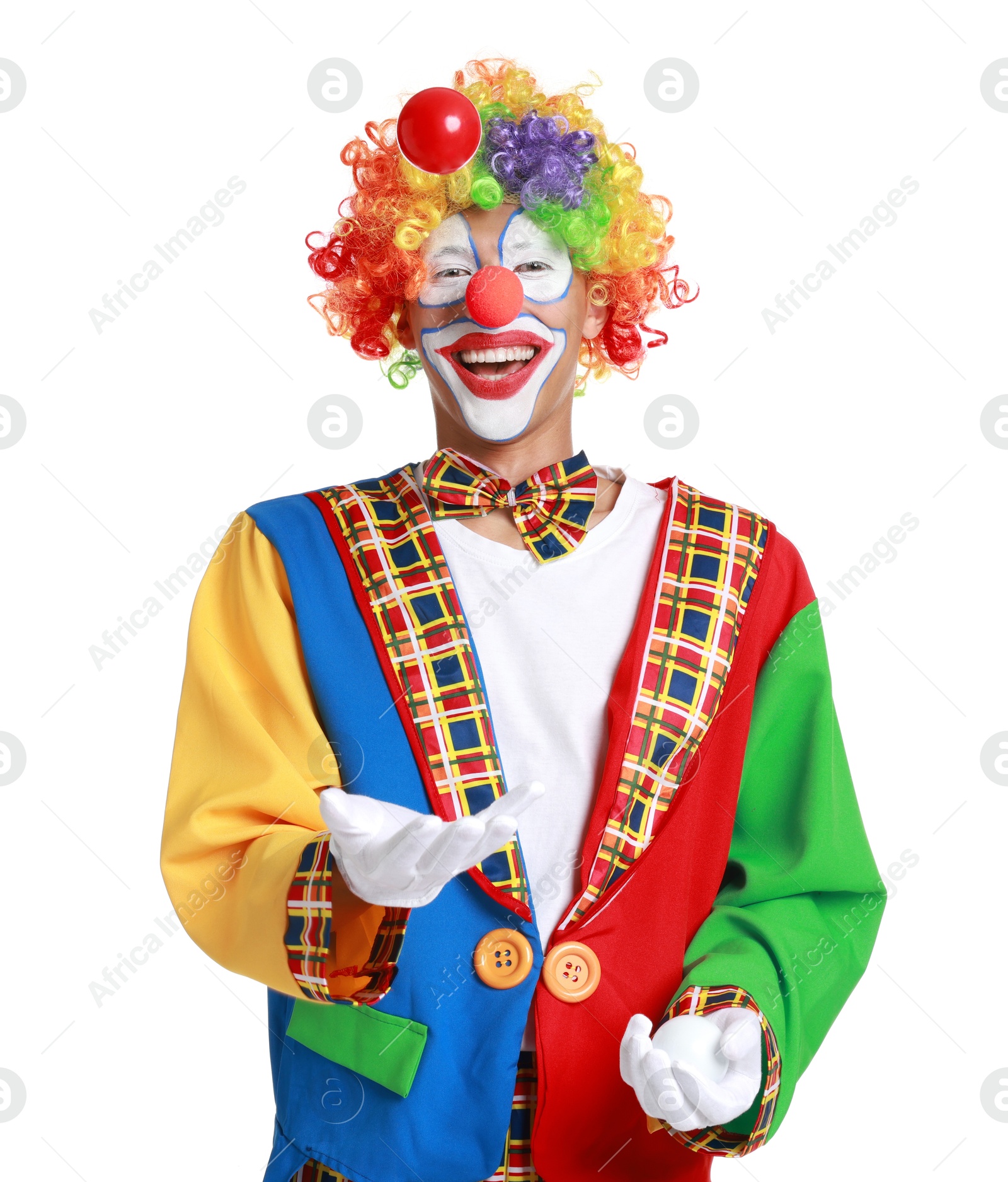 Photo of Happy clown juggling balls on white background