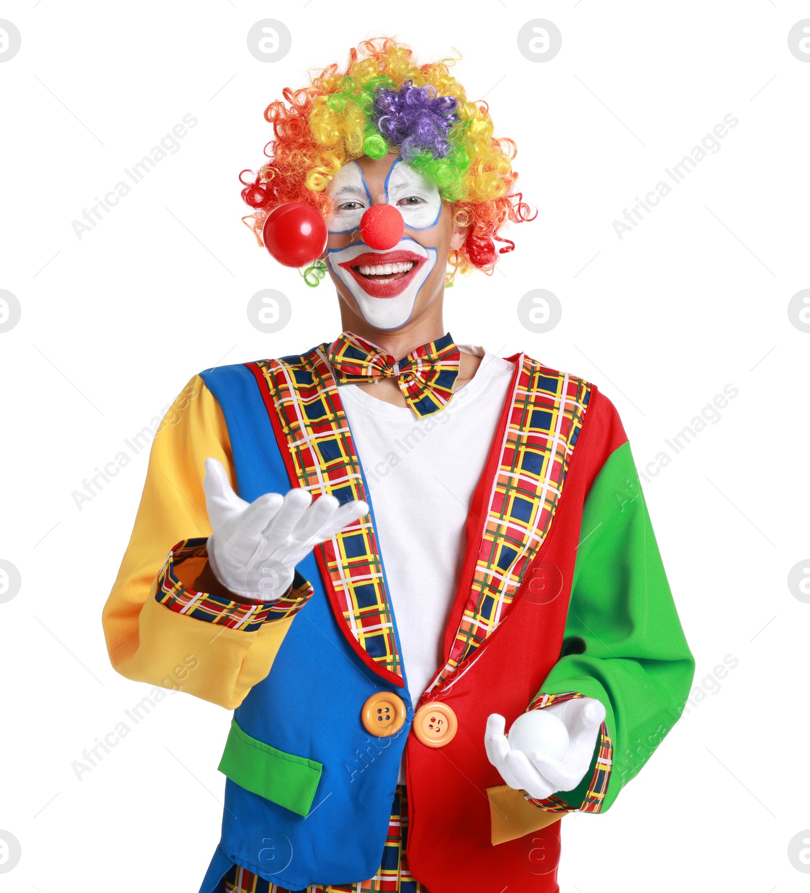 Photo of Happy clown juggling balls on white background