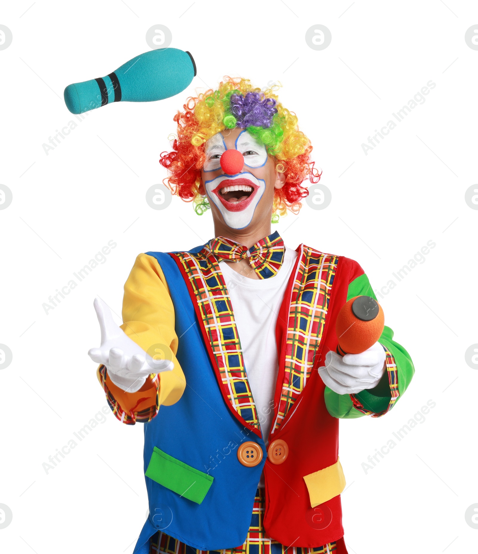 Photo of Happy clown juggling clubs on white background