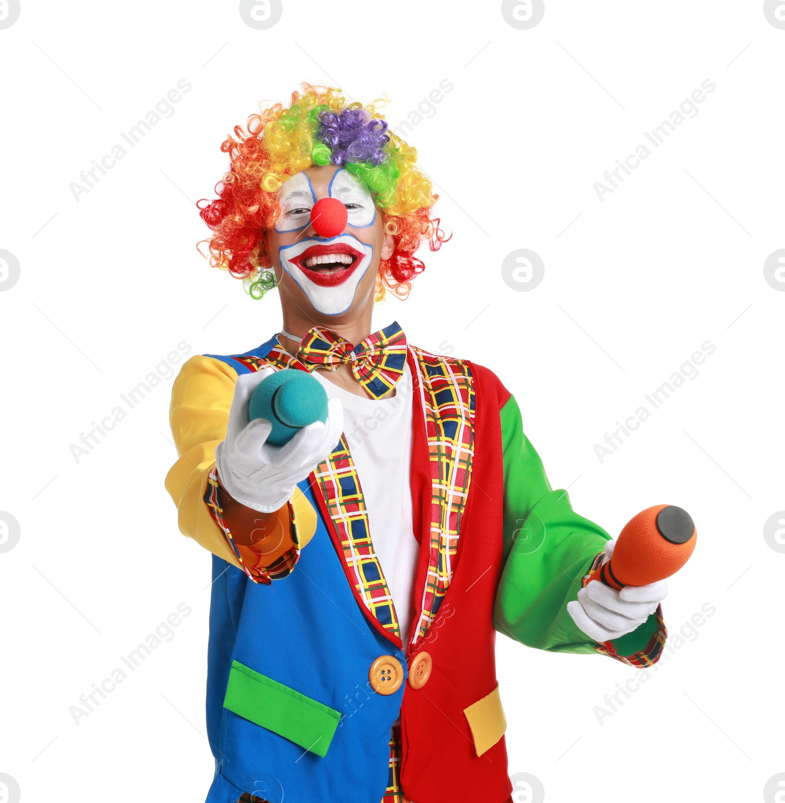 Photo of Happy clown juggling clubs on white background