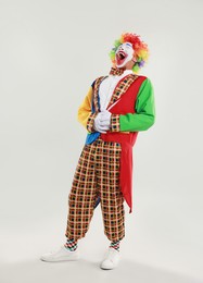 Photo of Portrait of clown laughing on light background