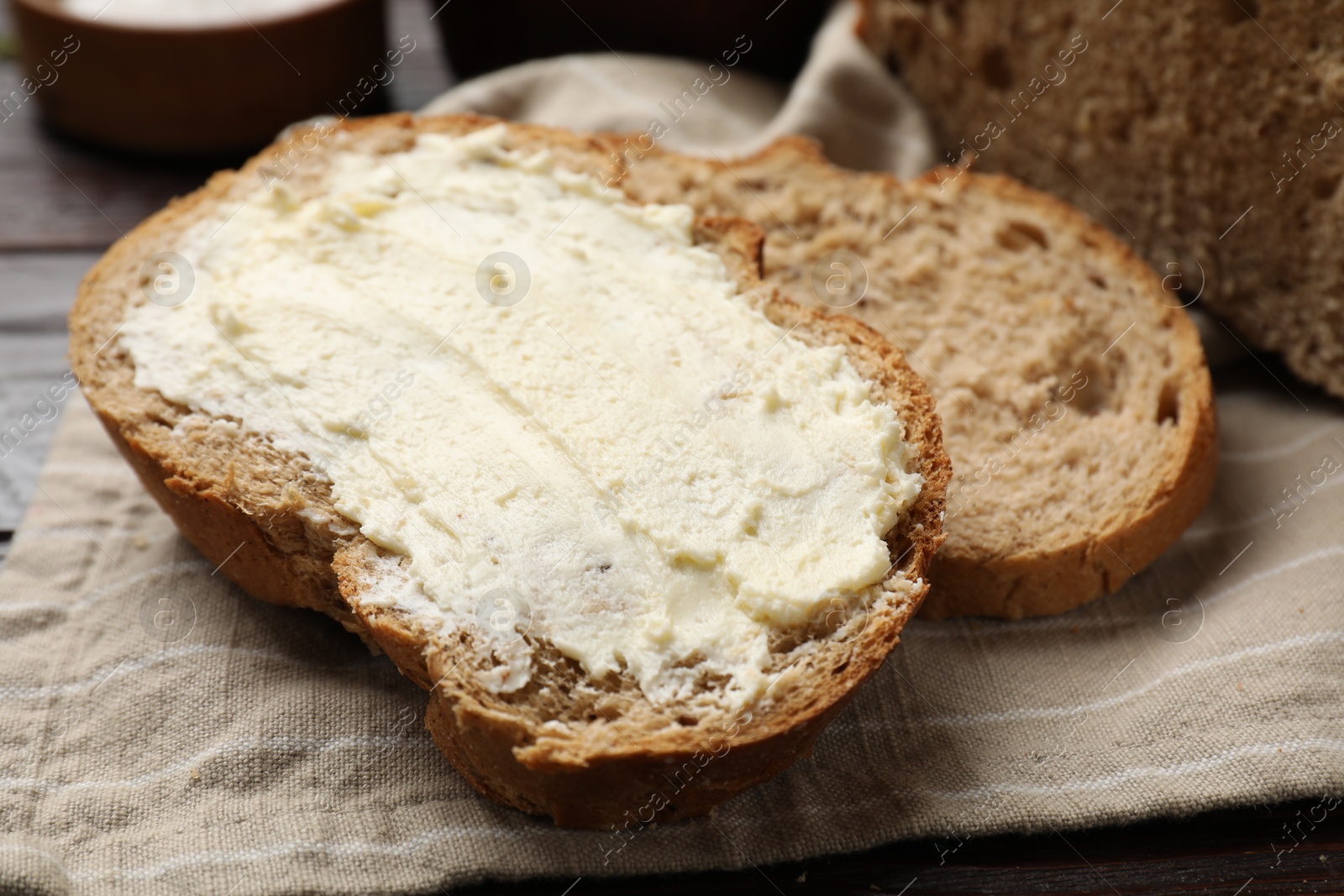 Photo of Fresh bread with butter on table, closeup