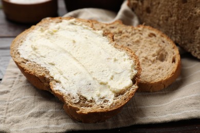 Photo of Fresh bread with butter on table, closeup