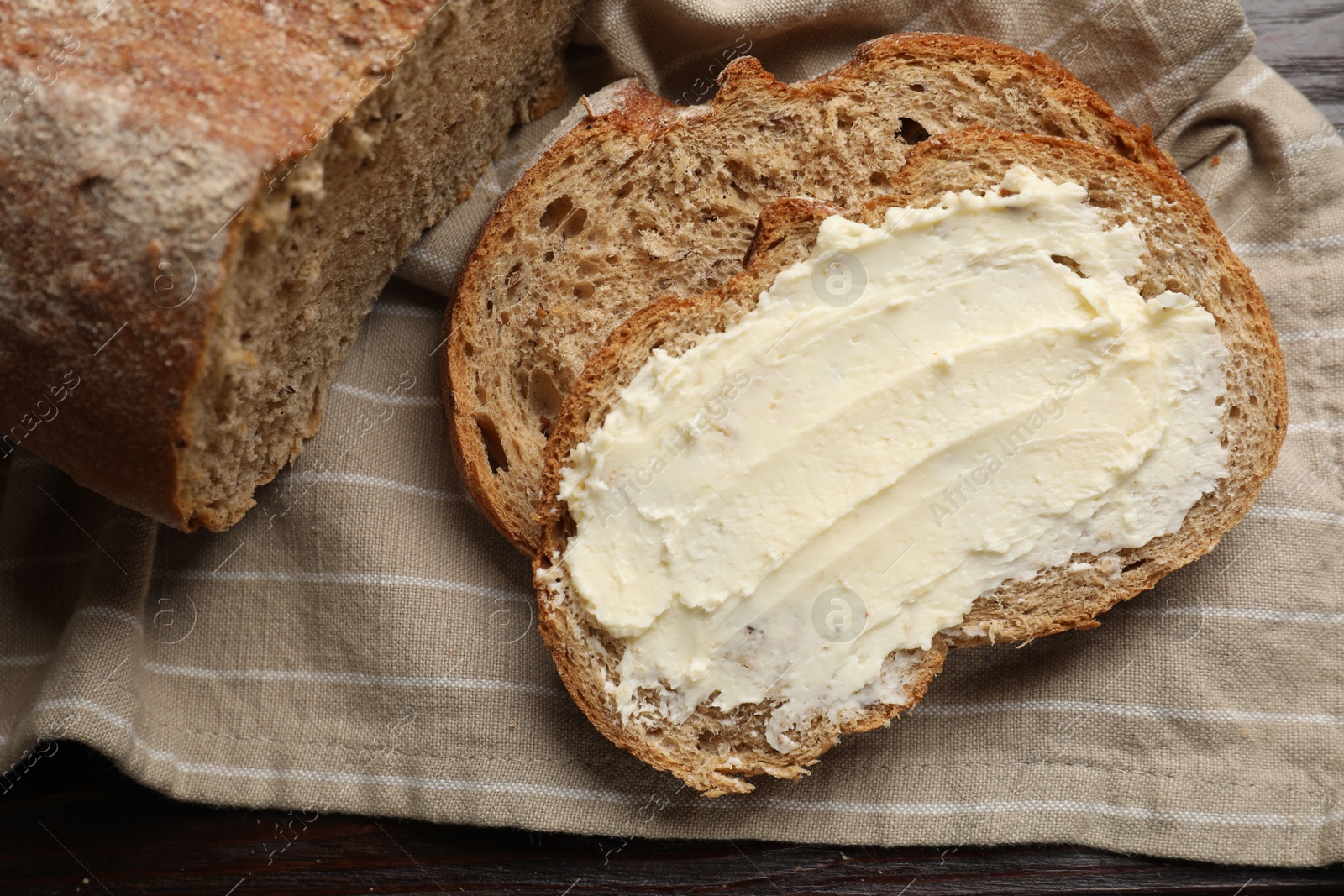 Fresh bread with butter on wooden table, top view Photo of Fresh bread with butter on wooden table, top view