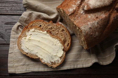 Photo of Fresh bread with butter on wooden table, top view