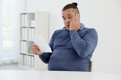 Photo of Overweight man with doctor's prescription in clinic