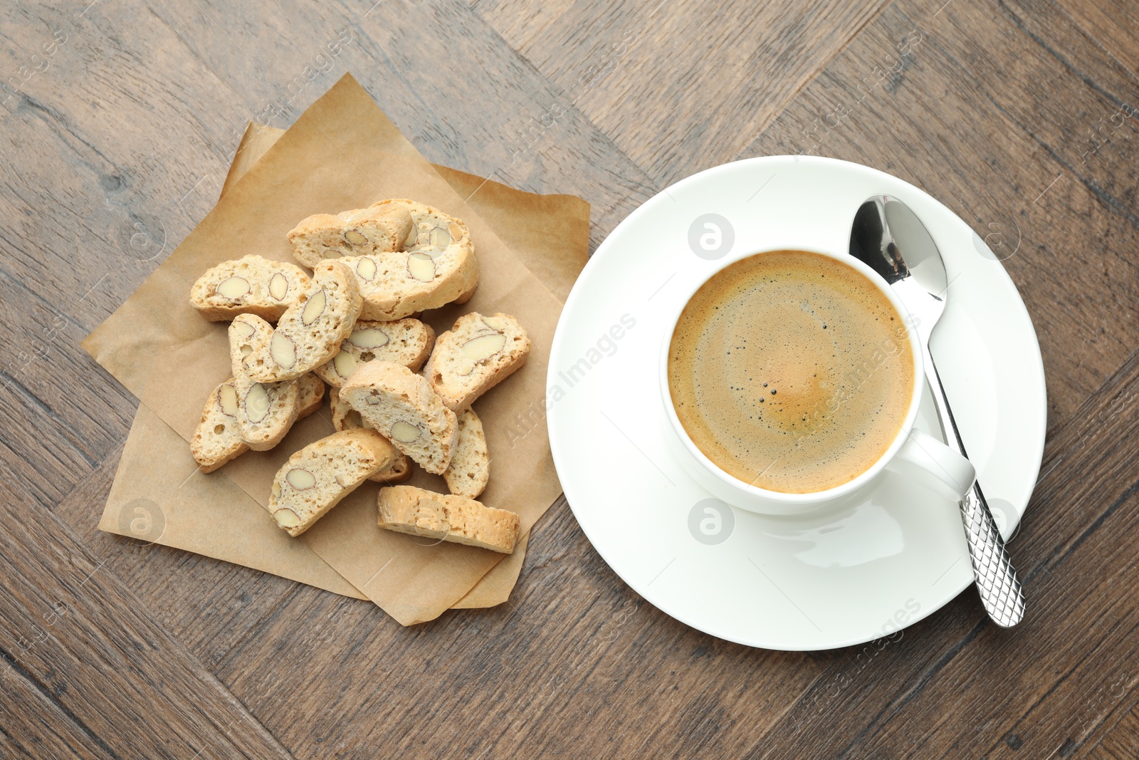 Photo of Traditional Italian almond biscuits (Cantucci) and coffee on wooden table, top view