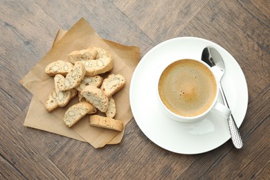 Photo of Traditional Italian almond biscuits (Cantucci) and coffee on wooden table, top view