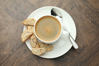 Traditional Italian almond biscuits (Cantucci) and coffee on wooden table, top view