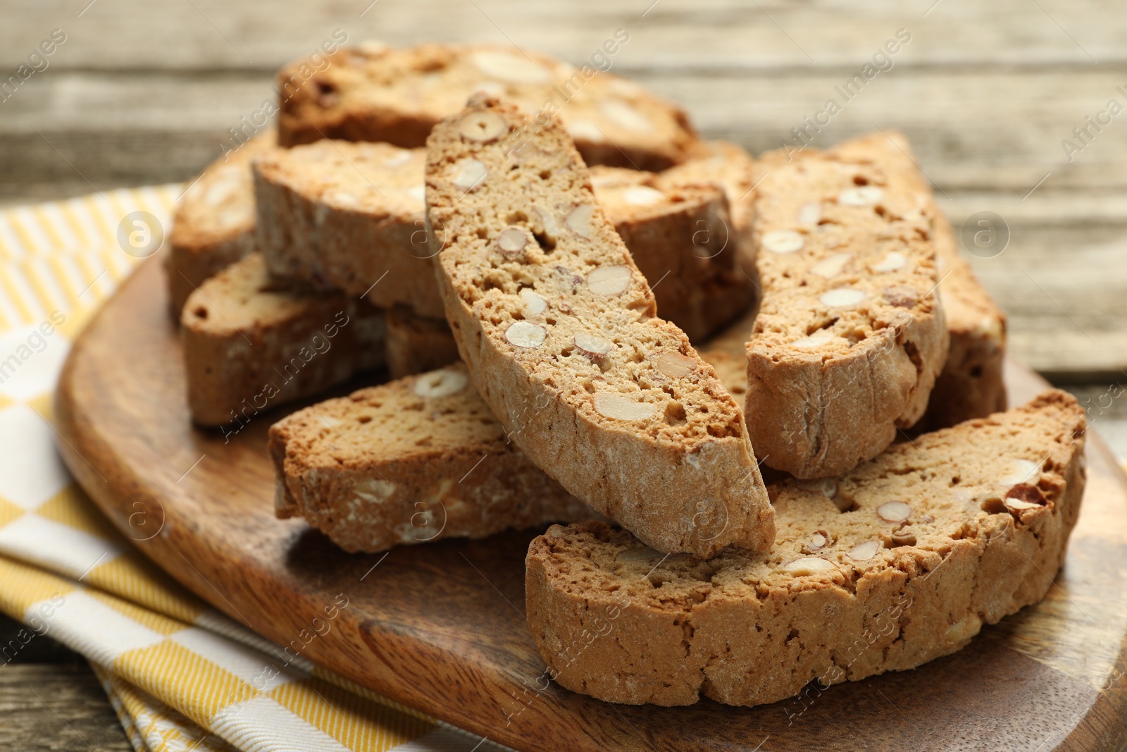 Photo of Traditional Italian almond biscuits (Cantucci) on wooden table, closeup