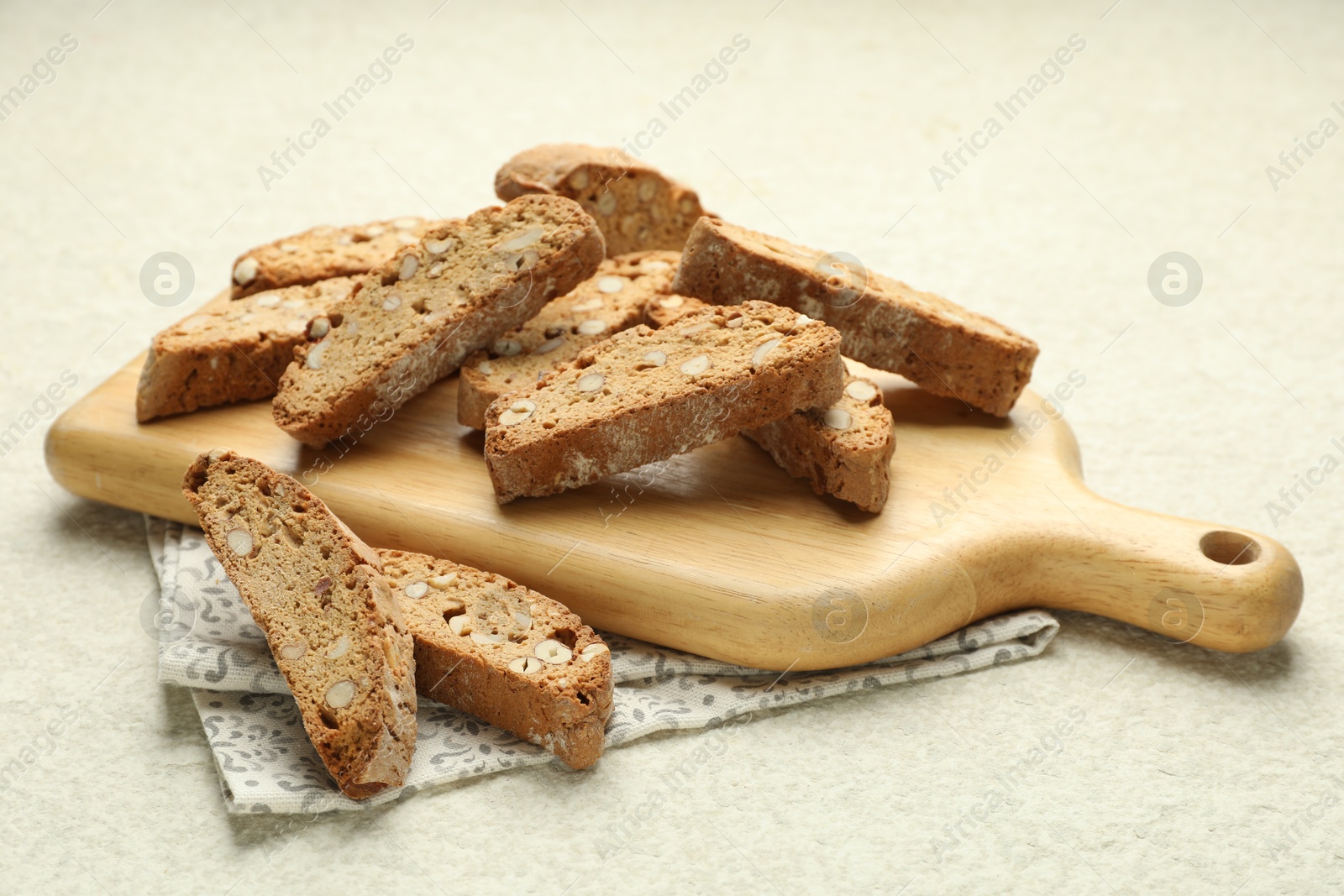 Photo of Traditional Italian almond biscuits (Cantucci) on light textured table, closeup