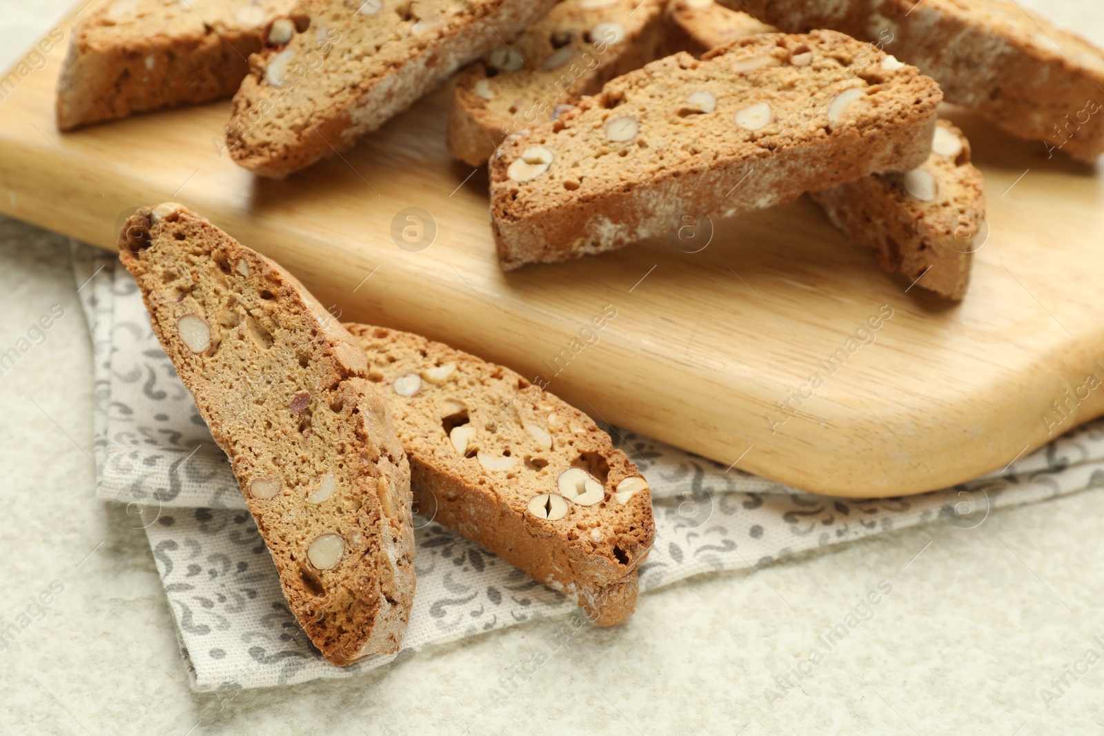 Photo of Traditional Italian almond biscuits (Cantucci) on light textured table, closeup