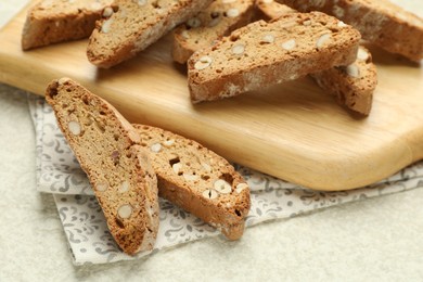 Traditional Italian almond biscuits (Cantucci) on light textured table, closeup