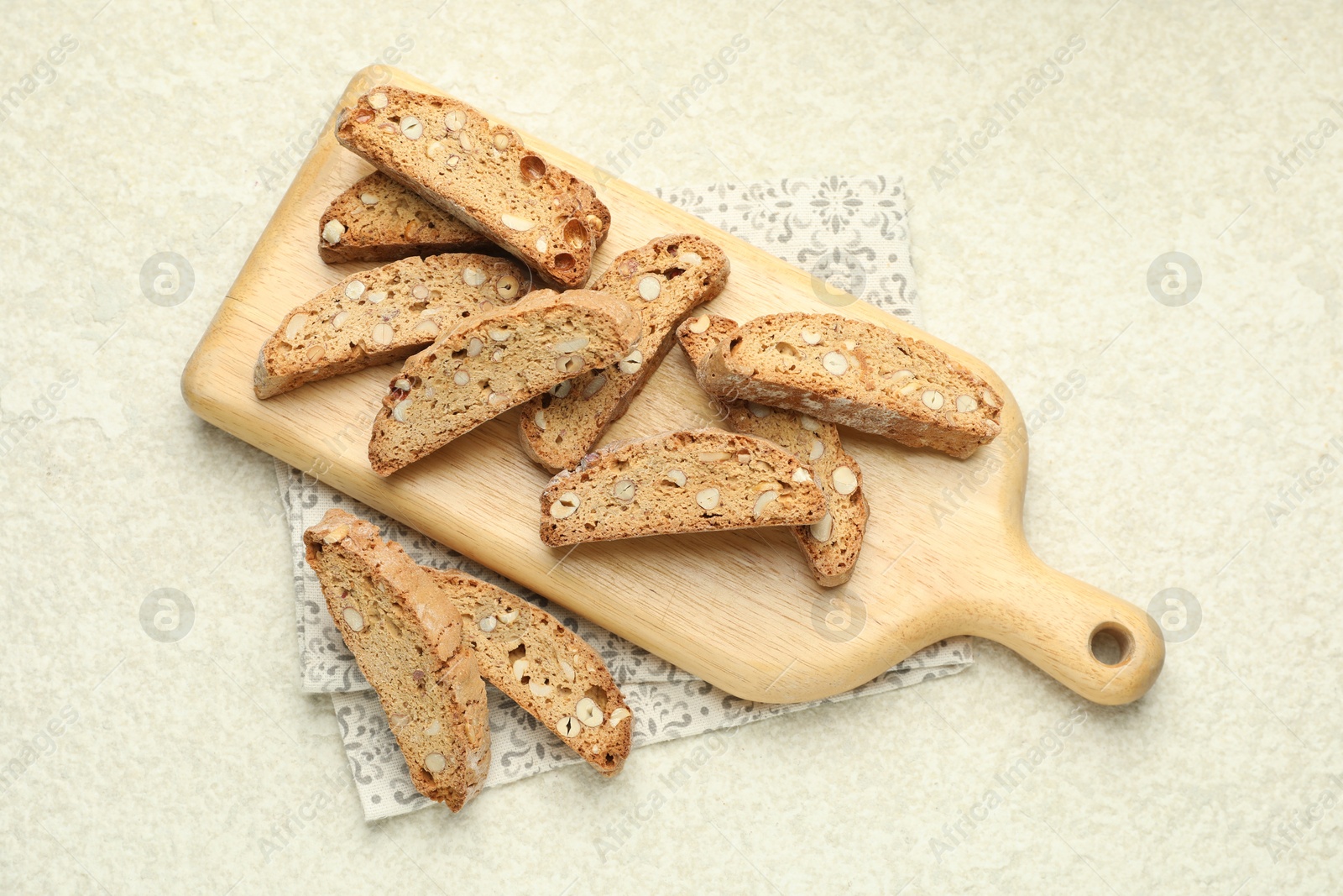 Photo of Traditional Italian almond biscuits (Cantucci) on light textured table, flat lay