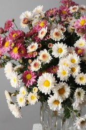 Photo of Beautiful white and pink flowers on gray background, closeup