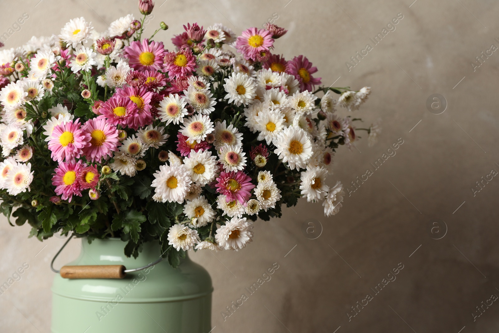 Photo of Beautiful flowers in modern vase on gray background, closeup. Space for text