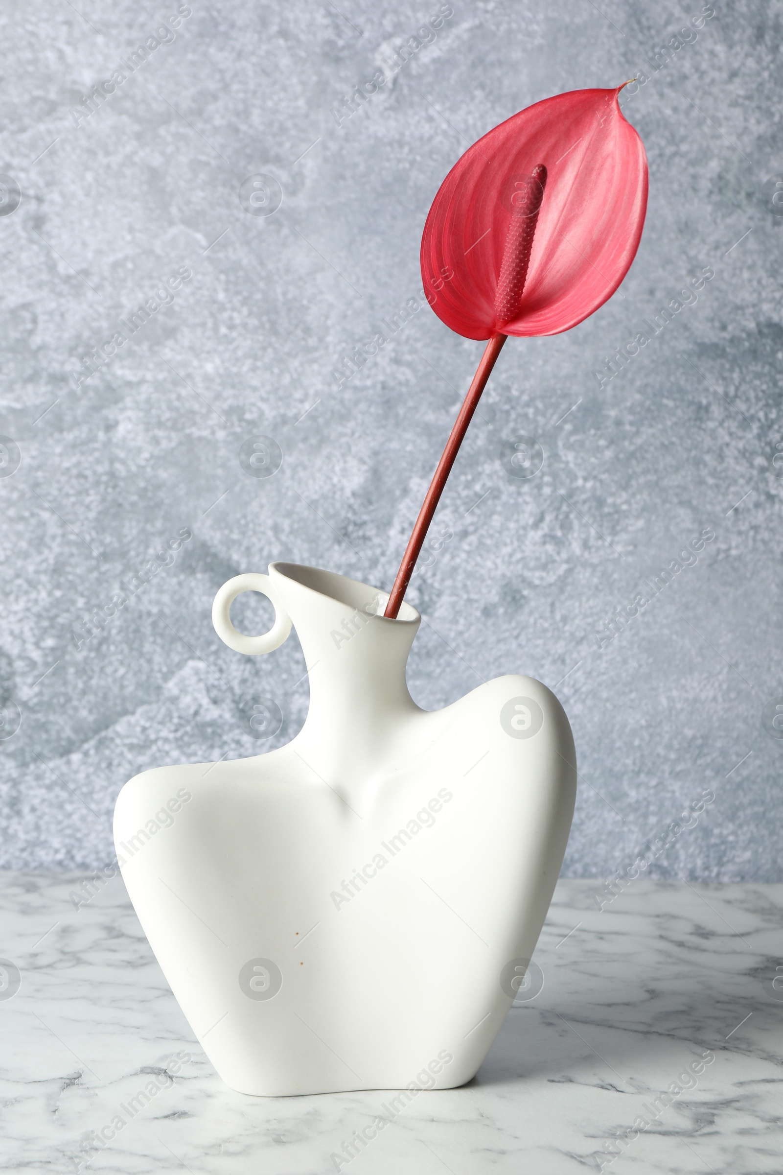 Photo of Beautiful tail flower in vase on marble table