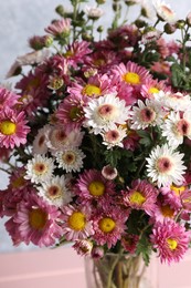 Photo of Beautiful chrysanthemum flowers on grey background, closeup