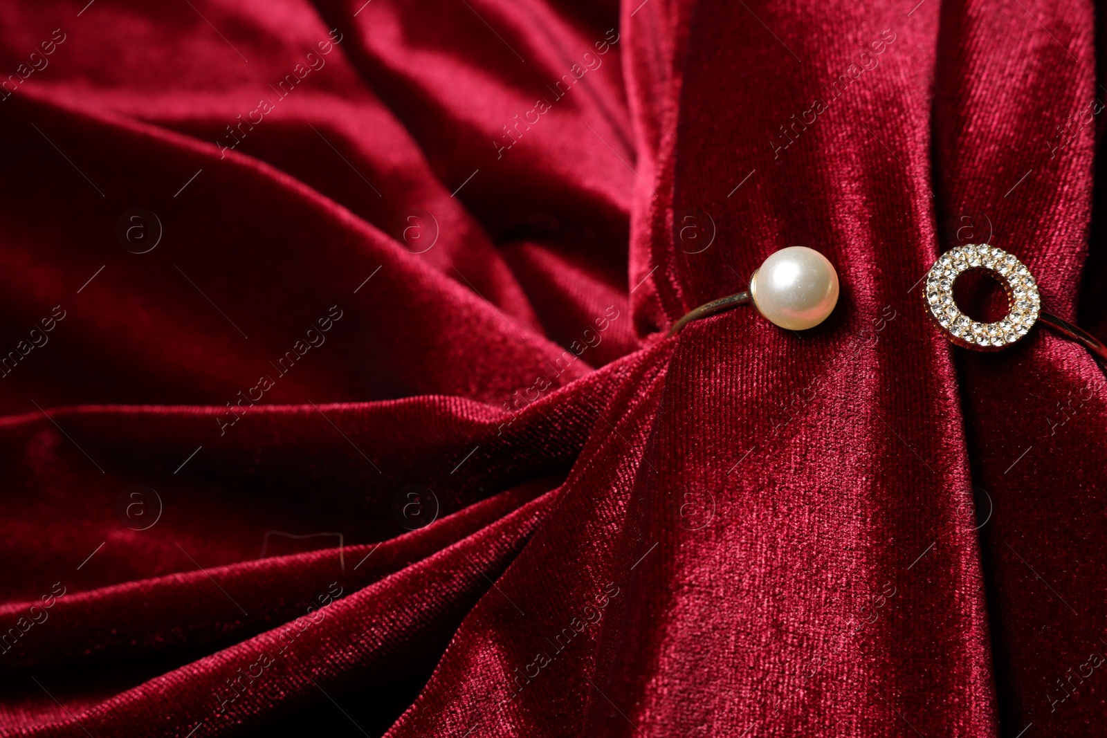 Photo of Beautiful bracelet with pearl and red cloth, closeup. Space for text