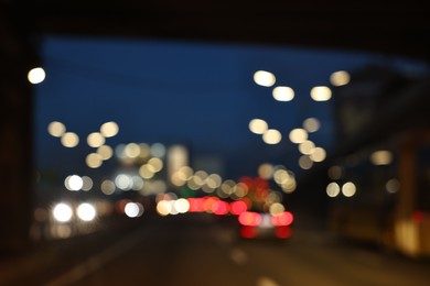 Photo of Blurred view of cityscape with road traffic and street lights in evening