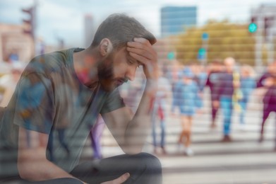 Loneliness. Sad man and crowded street, double exposure