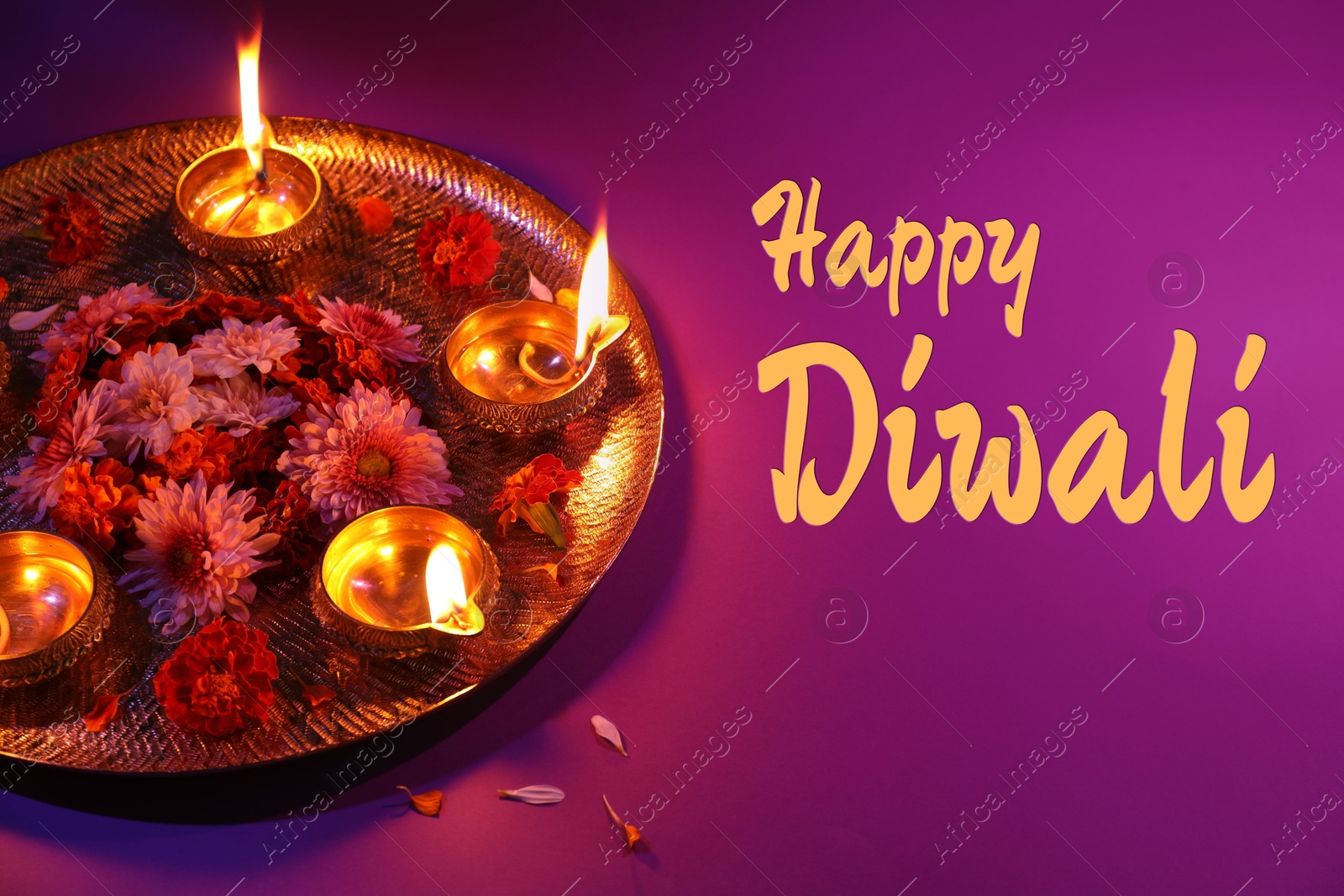 Image of Happy Diwali greeting card, Hindu festival of lights. Diya lamps and beautiful flowers on purple background