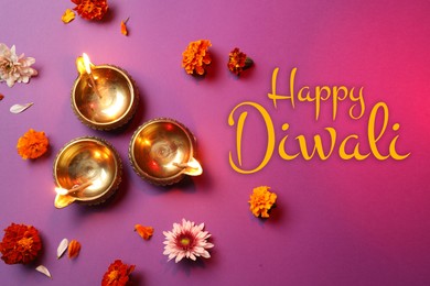 Image of Happy Diwali greeting card, Hindu festival of lights. Diya lamps and beautiful flowers on magenta color background, flat lay