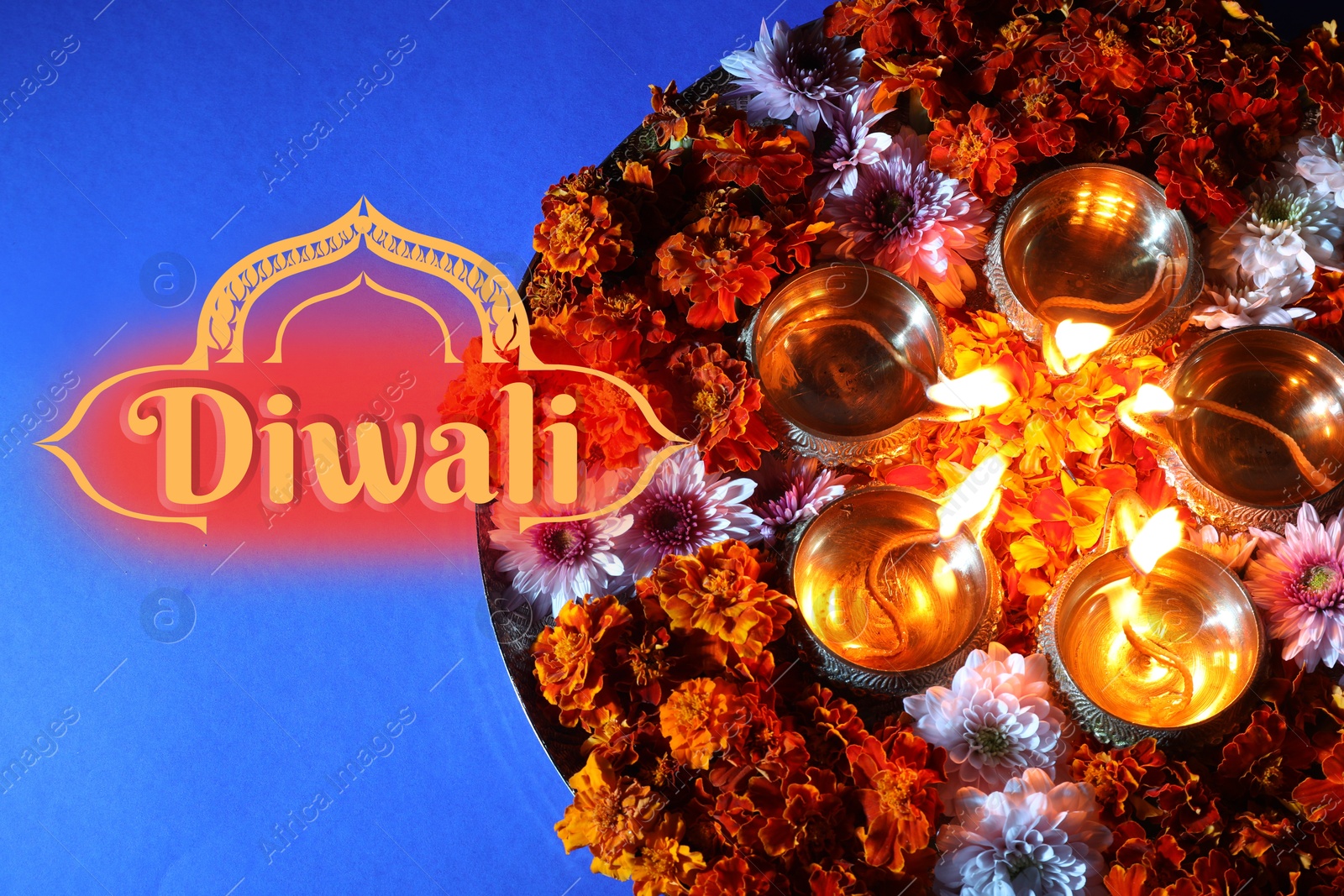 Image of Happy Diwali greeting card, Hindu festival of lights. Diya lamps and beautiful flowers on blue background, top view