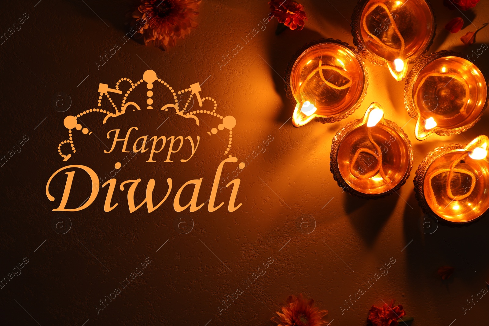 Image of Happy Diwali greeting card, Hindu festival of lights. Diya lamps and beautiful flowers on dark textured surface, flat lay