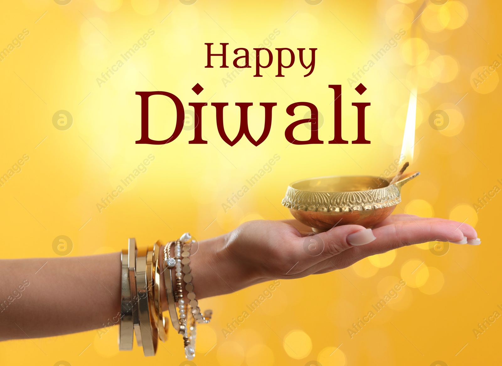 Image of Happy Diwali greeting card, Hindu festival of lights. Woman holding lit diya lamp on yellow background with blurred lights, closeup