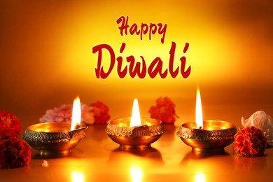 Image of Happy Diwali greeting card, Hindu festival of lights. Diya lamps and beautiful flowers on golden background