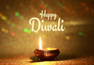 Image of Happy Diwali greeting card, Hindu festival of lights. Diya lamp on golden background