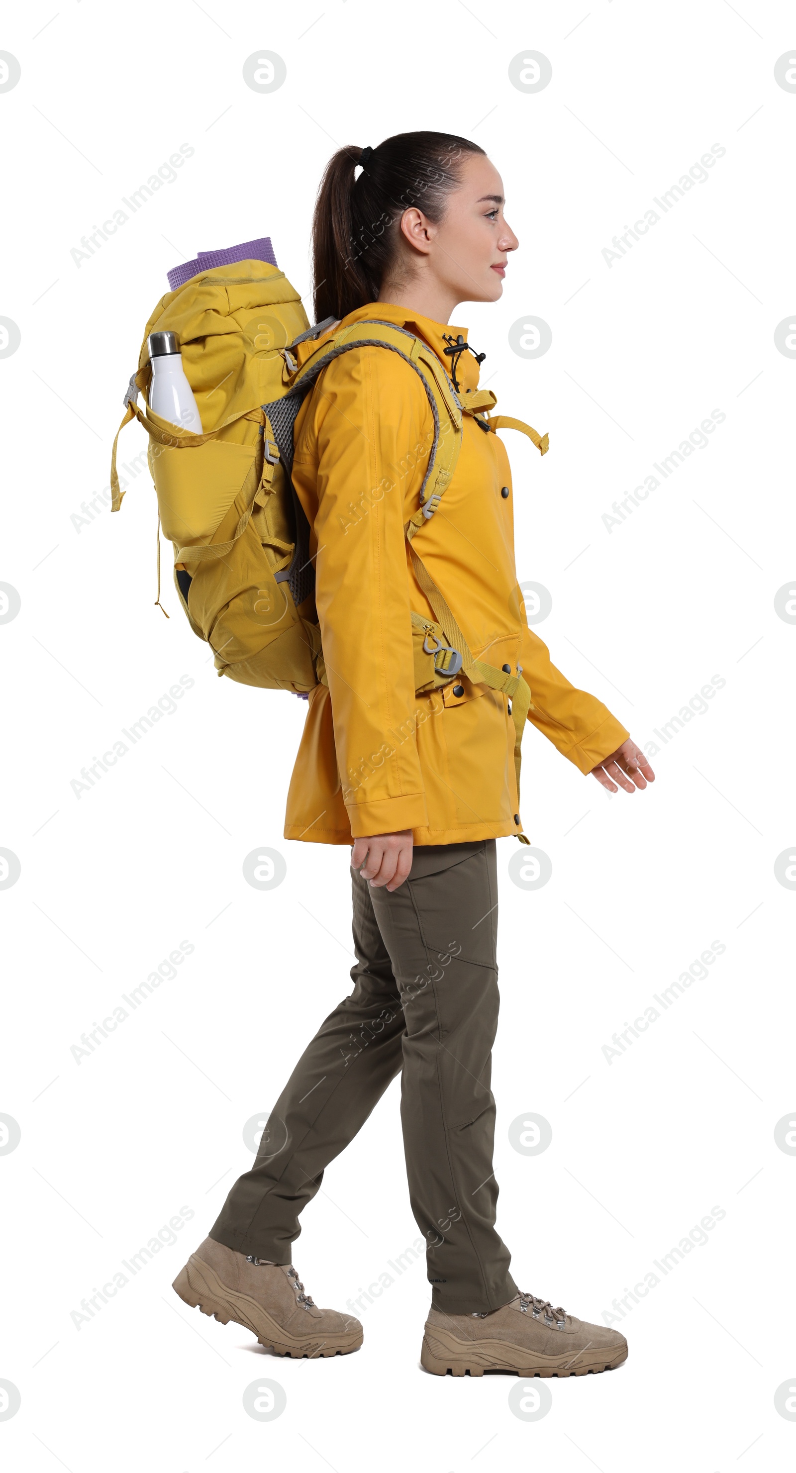 Photo of Young woman with backpack walking on white background. Active tourism