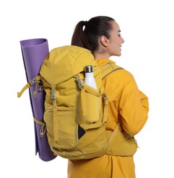 Young woman with backpack and mat on white background. Active tourism