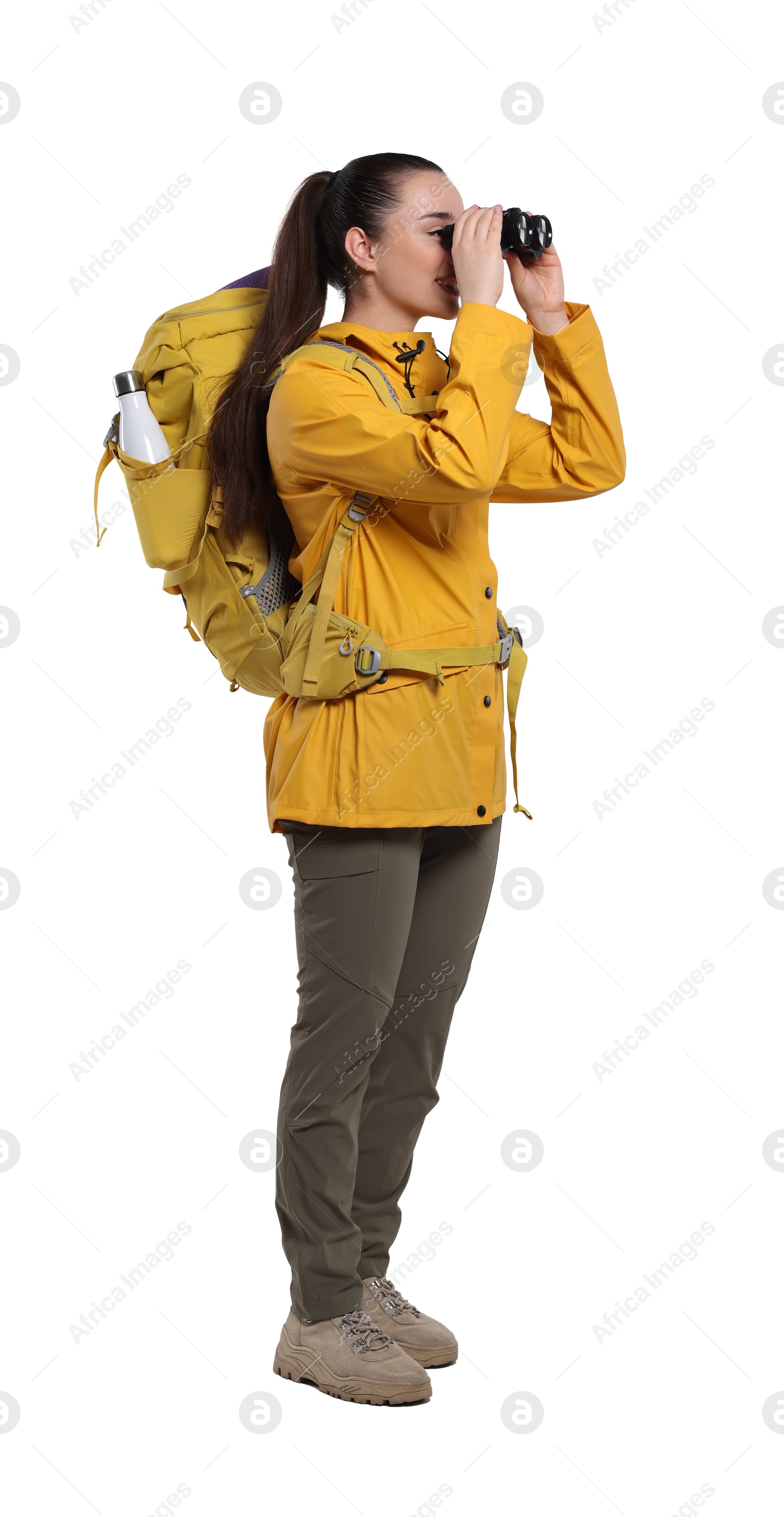 Photo of Young woman with backpack looking through binoculars on white background. Active tourism