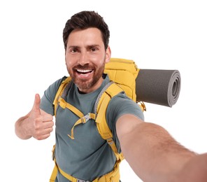 Photo of Happy man with backpack taking selfie and showing thumb up on white background. Active tourism