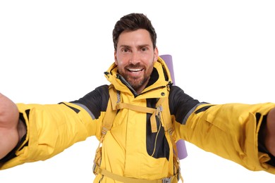 Happy man with backpack taking selfie on white background. Active tourism