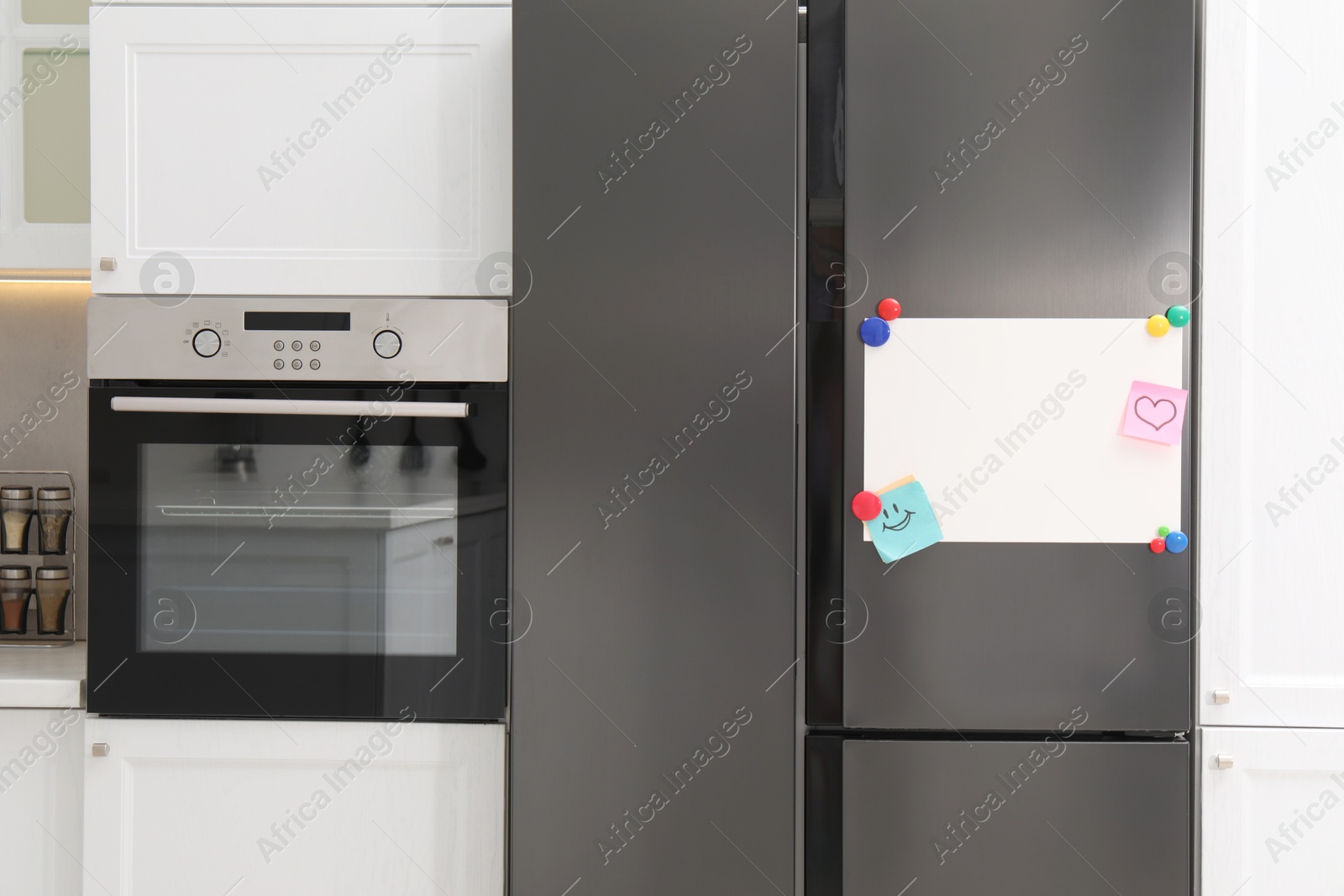 Photo of Blank magnetic board with notes on refrigerator in kitchen