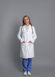 Photo of Portrait of doctor with stethoscope on gray background