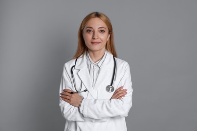 Photo of Portrait of doctor with stethoscope on gray background